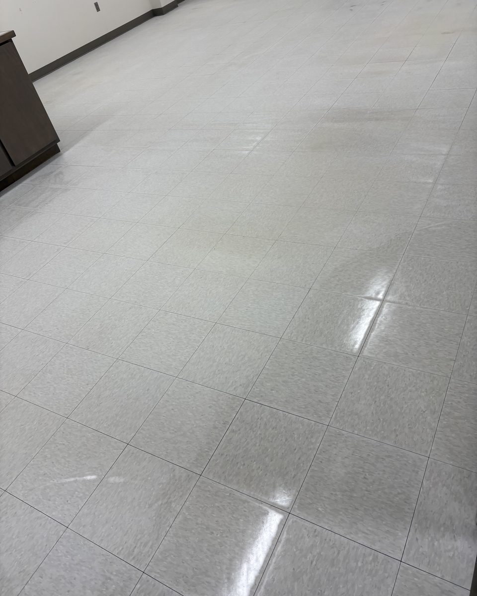 The same kind of VCT floor restored to a clean shine by Patriot Pro Cleaning